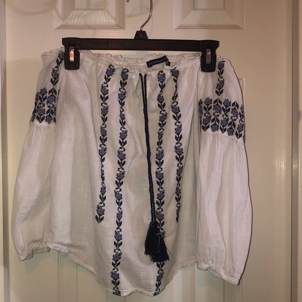 White off the shoulder top with blue embroidery